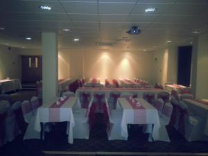 a banquet hall with tables and chairs in a room at The Windsor Hotel in Whitley Bay