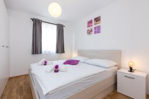 Postel nebo postele na pokoji v ubytování Apartments Kiara