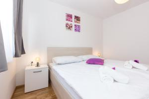 Postel nebo postele na pokoji v ubytování Apartments Kiara