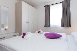 Postel nebo postele na pokoji v ubytování Apartments Kiara