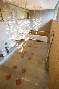 a lobby with a large chandelier in a building at Day Nice Hotel Tokyo in Tokyo