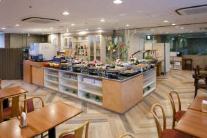 a kitchen with a counter with food on it at Day Nice Hotel Tokyo in Tokyo