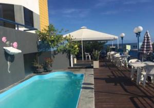 uma piscina ao lado de um edifício em Hotel Praia da Sereia em Salvador