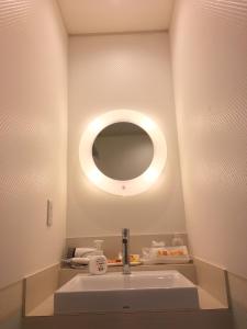 a bathroom with a sink and a mirror at Business Hotel La Firenze in Tokyo