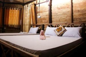 a large bed in a room with two bedsitures at Scoop Cabana Kitesurfing in Kalpitiya