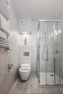 a bathroom with a toilet and a glass shower at Hotel Barlinek in Barlinek