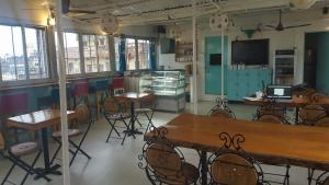 a restaurant with tables and chairs in a room at Baba Guest House in Varanasi