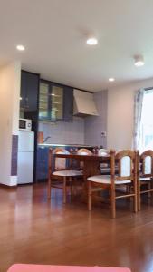 a kitchen with a table and chairs and a refrigerator at Cottage Ginkai Fuji in Yamanakako +25 photos