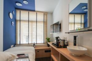 a bathroom with a counter with a sink and a bed at Amistad hotel in Amsterdam +64 photos