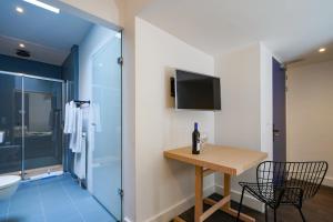 a bathroom with a table and a shower at Amistad hotel in Amsterdam