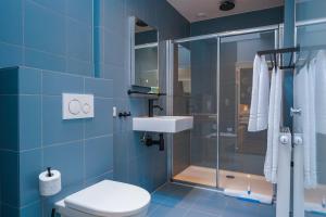 a bathroom with a shower and a toilet and a sink at Amistad hotel in Amsterdam +46 photos