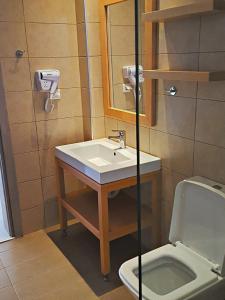 a bathroom with a sink and a toilet at Minimalistic Apartment Near the Sea in Gouves