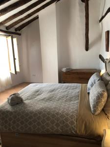 a bedroom with a large bed with pillows on it at El Portal de Moratalla in Moratalla
