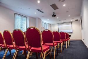 a conference room with red chairs and a chalkboard at Hotel Pushkin in Oral