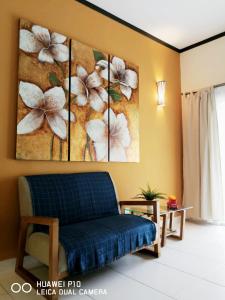 a room with a couch and a painting on the wall at M.R Homestay Morib Gold Coast Resort in Banting