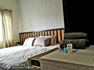 a bedroom with a bed and a table with a laptop at M.R Homestay Morib Gold Coast Resort in Banting