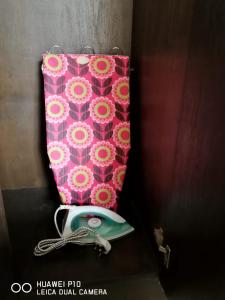 a pink pillow next to a pink pillow with a purse at M.R Homestay Morib Gold Coast Resort in Banting