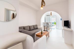 a living room with a couch and a table at Plaka Suites in Plaka Milou