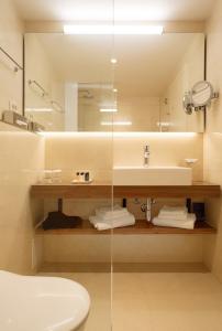 a bathroom with a sink and a mirror at Grand Hotel Bernardin in Portorož