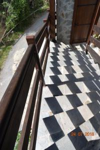 a wooden bench sitting on a sidewalk next to a door at Mouson Melathron in Elafina