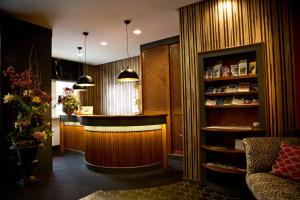 a bar in a room with a book shelf at Hotel Karpfen in Eberbach