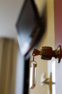 a bottle of wine hanging from a door handle at Hotel Continental in Angers