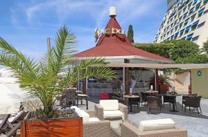 a patio with a gazebo with chairs and tables at Grand Hotel Bernardin in Portorož