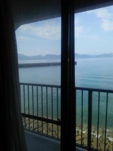 a view of the ocean from a hotel room window at Minshuku Kamagari in Kure