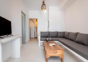 a living room with a couch and a coffee table at Plaka Suites in Plaka Milou