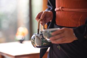 a person holding a handbag with a spoon at Hotel Okura Amsterdam – The Leading Hotels of the World in Amsterdam