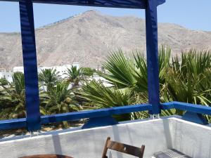 a view from a balcony with a mountain in the background at Villa Spyros Santorini in Perissa