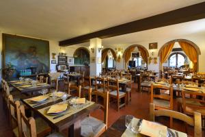 a dining room with wooden tables and chairs at Palazzo Danesi in Montepulciano