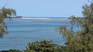 a view of a large body of water with trees at Joao's Place in Vila Praia Do Bilene