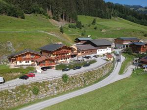 an aerial view of a resort with cars parked on a road at Appartmenthof Aigengut Ferienwohnung Großarl in Grossarl