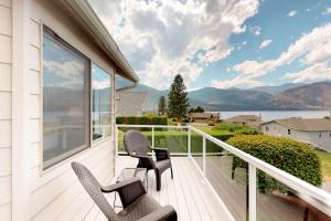 a balcony with two chairs and a view of the water at Wapato Point Lakeview in Manson