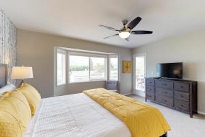 a bedroom with a bed and a ceiling fan at Wapato Point Lakeview in Manson +33 photos