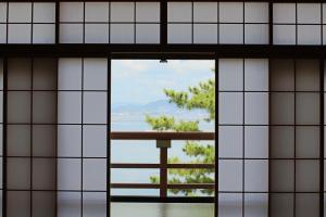 a view through the window of a building at Miyajima Seaside Hotel in Miyajima