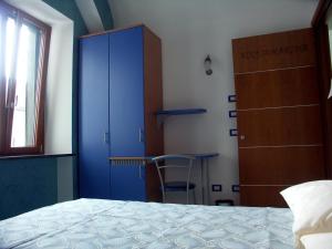 a bedroom with a blue cabinet and a table at MeFra Camere - Amalfi Coast in Atrani