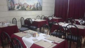a dining room with tables and chairs with red table cloth at Razan Hotel in Amman +23 photos