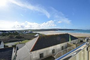 a view of the beach from the balcony of a building at The Penellen guest accommodation room only in Hayle