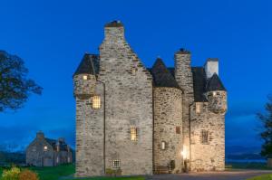 an old castle with turrets at dusk at Barcaldine Castle in Oban +53 photos