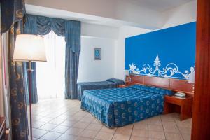 Postel nebo postele na pokoji v ubytování Assinos Palace Hotel