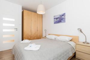 Posteľ alebo postele v izbe v ubytovaní Apartamenty Polanki Park BASEN, SAUNA & SIŁOWNIA by Noclegi Renters