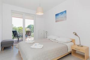 Posteľ alebo postele v izbe v ubytovaní Apartamenty Polanki Park BASEN, SAUNA & SIŁOWNIA by Noclegi Renters