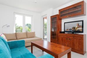 Televízia a/alebo spoločenská miestnosť v ubytovaní Apartamenty Polanki Park BASEN, SAUNA & SIŁOWNIA by Noclegi Renters