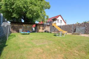 a playground with a slide in a yard at Ferienwohnung Sperlingslust in Niepars