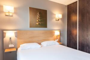 Ένα ή περισσότερα κρεβάτια σε δωμάτιο στο Residhotel Le Grand Prado
