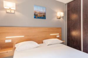 Ένα ή περισσότερα κρεβάτια σε δωμάτιο στο Residhotel Le Grand Prado