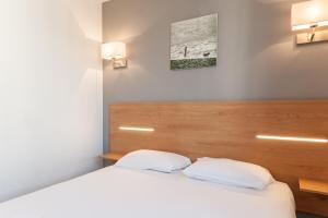 Ένα ή περισσότερα κρεβάτια σε δωμάτιο στο Residhotel Le Grand Prado