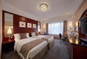 Voodi või voodid majutusasutuse Hotel Royal Macau toas